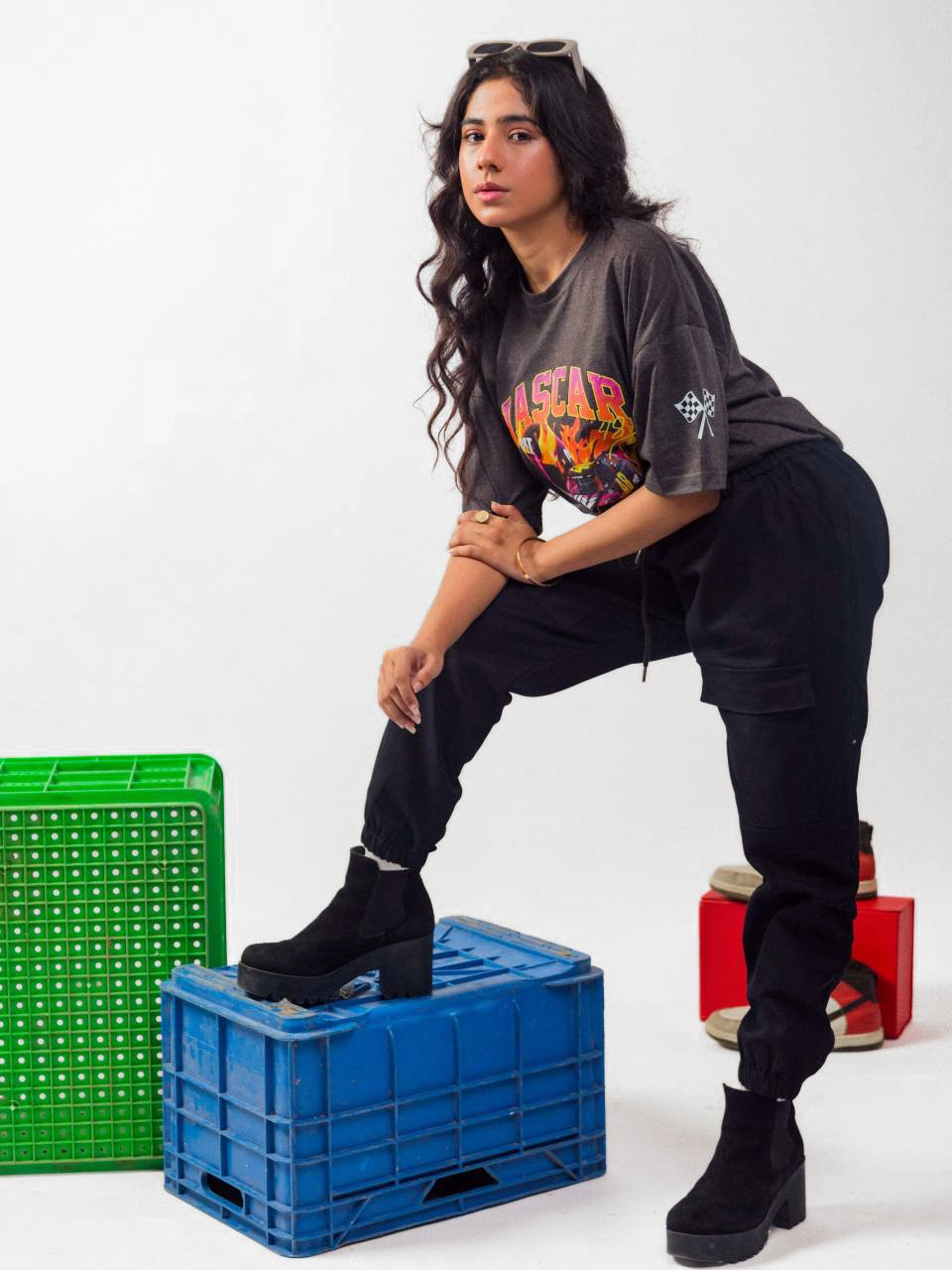 Female model wearing charcoal nascar oversized graphic t shirt showing the left side view
