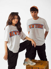 male and female model wearing white newyork oversized graphic t shirt showing front and right side of the t shirt while standing