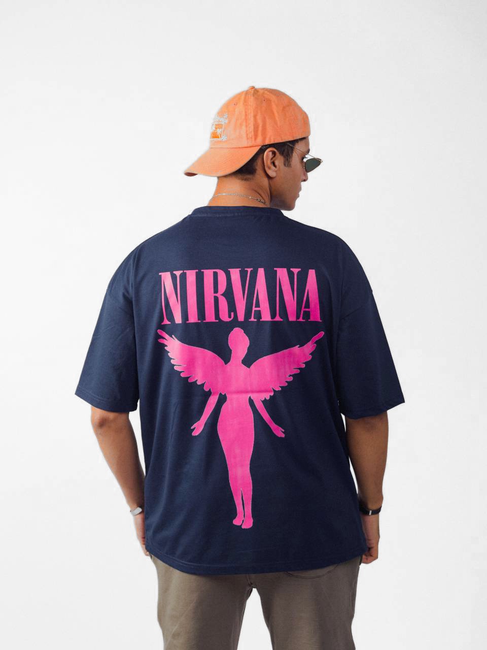 male model wearing blue nirvana oversized graphic t shirt showing the back side of the t shirt