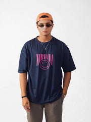 male model wearing blue nirvana oversized graphic t shirt showing the front side of the t shirt while standing