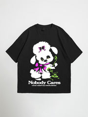 Black nobody cares oversized graphic t-shirt with a white poodle graphic and 'Nobody Cares' text on a light gray background
