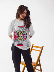Female model wearing Party King oversized white graphic t-shirt Attire Essentials