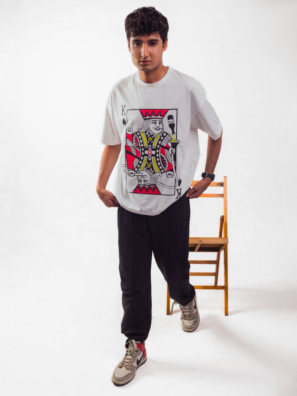 Male model wearing Party King oversized white graphic t-shirt Attire Essentials