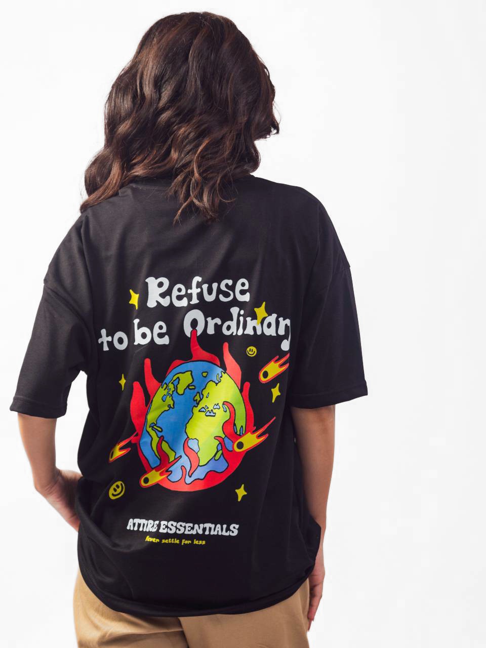 female model wearing black refuse to be ordinary oversized graphic t shirt showing back view of the t shirt while standing