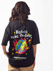 female model wearing black refuse to be ordinary oversized graphic t shirt showing back view of the t shirt while standing