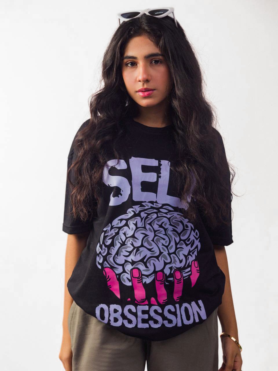 Female model wearing black self obsession oversized graphic t shirt showing front side 