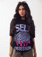 Female model wearing black self obsession oversized graphic t shirt showing front side 