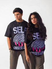 Female and male model wearing black self obsession oversized graphic t shirt showing front side 