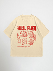 Beige shell beach club oversized graphic t-shirt with red 'Shell Beach Club' text and shell graphics on a light gray background