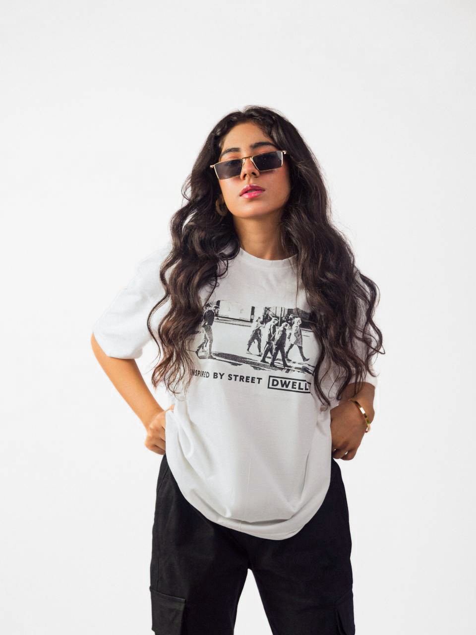 female model wearing white street dwellers oversized graphic t shirt showing the front side