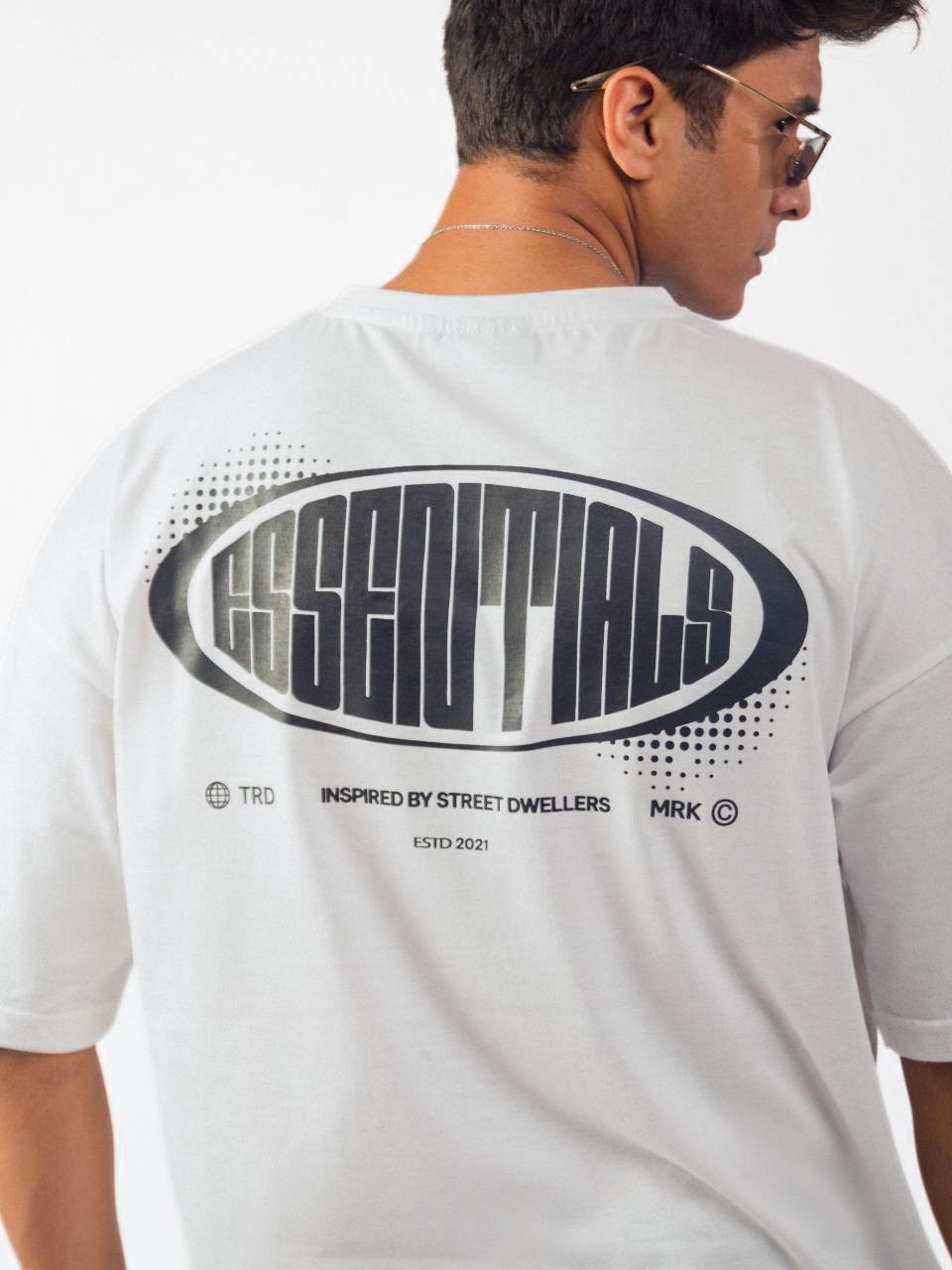 male model wearing white street dwellers oversized graphic t shirt showing the back side in detailed view