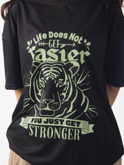 female model wearing black you just get stronger oversized graphic t shirt showing the front side in detailed view