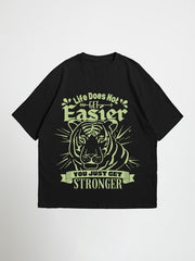 Black you just get stronger oversized graphic t-shirt with a tiger graphic and motivational quote on a white background